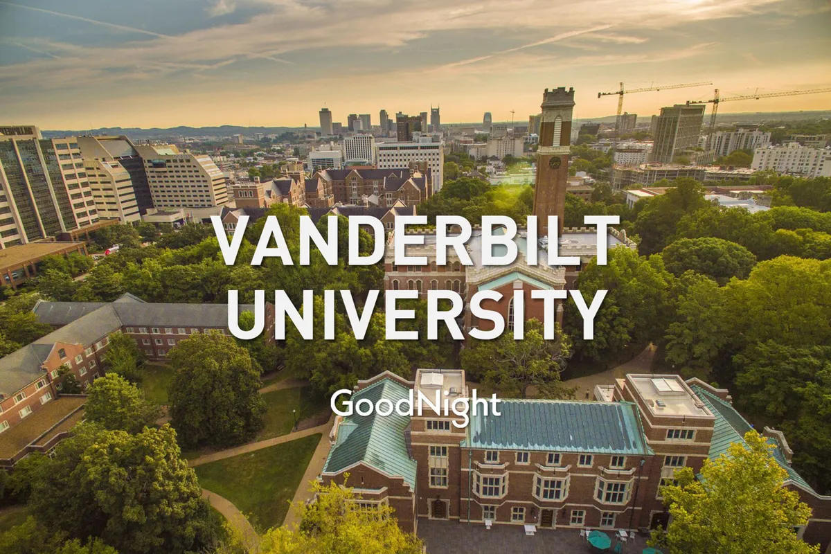 A view of Vanderbilt University’s iconic clock tower rising above lush greenery, set against the urban Nashville skyline. The scene is serene, combining academic gravitas with a sense of location.