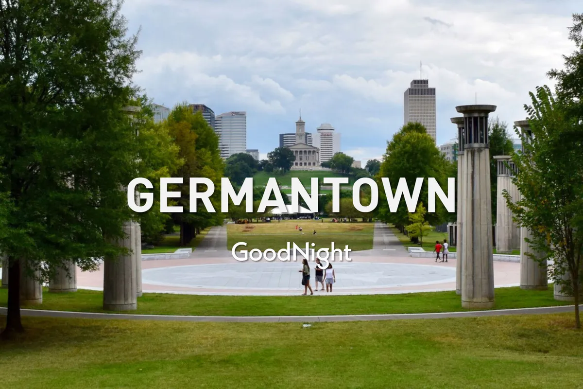 This image captures a large, open park area with well-kept pathways, people strolling, and the Nashville city skyline in the background. The tranquil setting and visible activity evoke a family-friendly atmosphere perfect for outdoor relaxation and exploration.