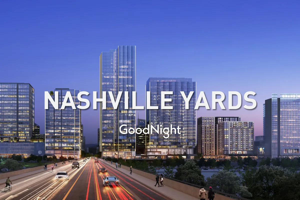 A lively streetscape featuring tall buildings, busy roads, and pedestrians enjoying city life at dusk. The sense of movement and urban energy highlights Nashville’s central hub atmosphere, emphasizing easy access to nearby attractions and venues.